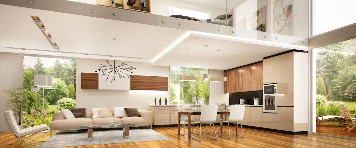 Inside of a modern living room and kitchen area with a loft overhead.