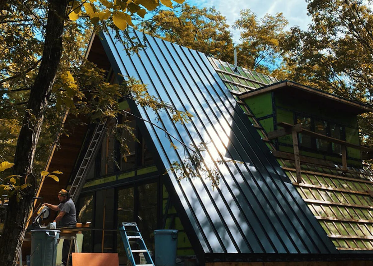 How to build a custom home: worker cleaning the windows of a house